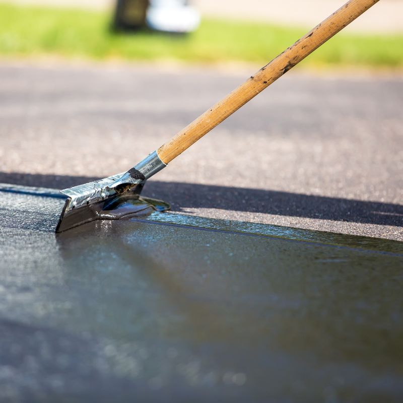 Sealcoating asphalt surface